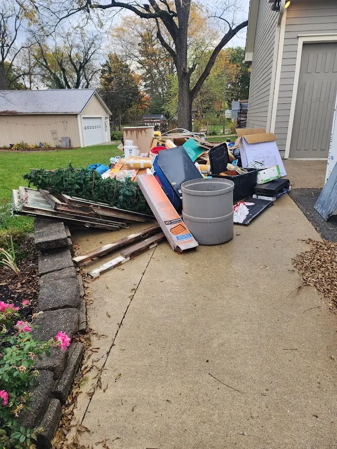 Dumpster being loaded with debris for Demolition Dumpster Rental in Elyria